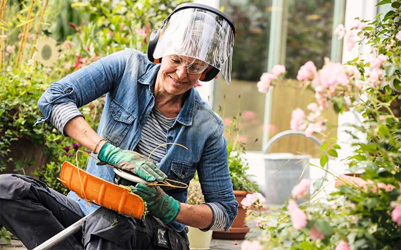 Woman refilling line trimmer nylon line